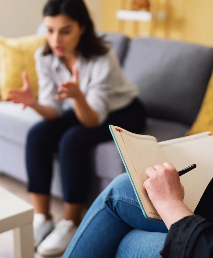 Woman talking to clinician with clipboard Woman talking to clinician with clipboard
